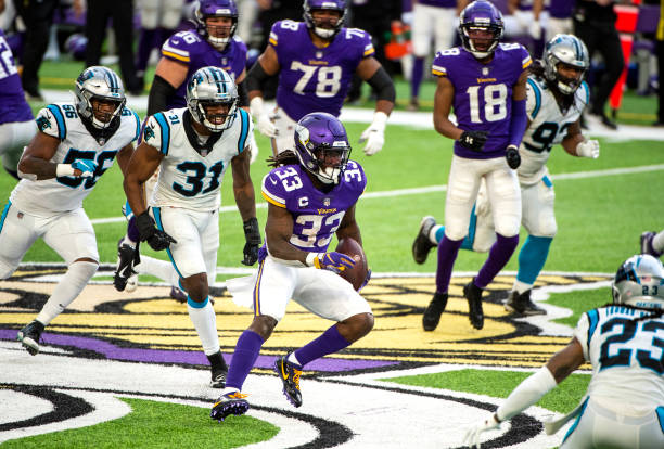 Dalvin Cook of the Minnesota Vikings runs with the ball in the fourth quarter of the game against the Carolina Panthers at U.S. Bank Stadium on...