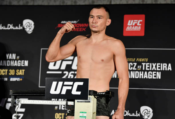 Damir Ismagulov of Russia poses on the scale during the UFC 267 official weigh-in at Hilton Abu Dhabi Yas Island on October 29, 2021 in Abu Dhabi,...