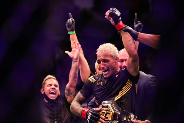 Dana White places the belt on Charles Oliveira after he defeated Michael Chandler during their Championship Lightweight Bout of UFC 262 at Toyota...