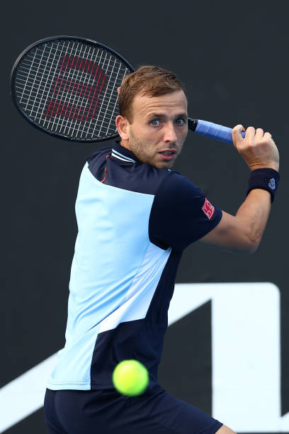 Daniel Evans of Great Britain plays a backhand in his first round singles match against David Goffin of Belgium during day two of the 2022 Australian...