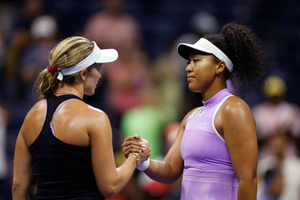 Danielle Collins of the United States shakes hands with Naomi Osaka of Japan after defeating her in their Women's Singles First Round match on Day...