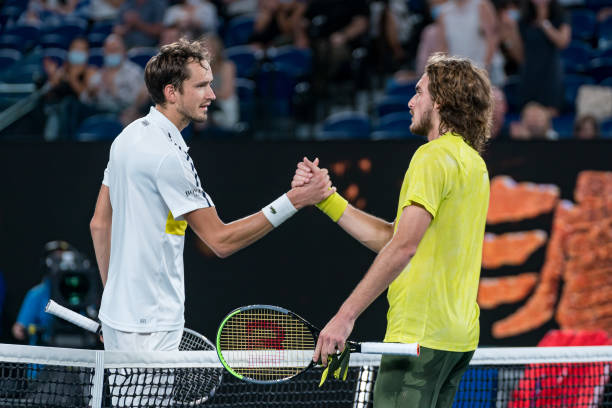 Daniil Medvedev of Russia and Stefanos Tsitsipas of Greece embrace at the net following their Men's Singles Semifinals match during day 12 of the...
