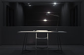 Dark interrogation room with switched-on lamp and big mirror, 3d rendering.