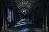 Dark Palace Hallway with lit candles and moonlight shining through the windows, 3d render.