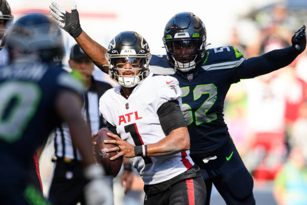Darrell Taylor of the Seattle Seahawks prepares to tackle Marcus Mariota of the Atlanta Falcons during the second half of the game at Lumen Field on...