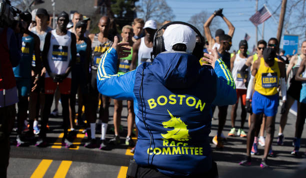 Dave McGillivray, race director of the Boston Marathon, directs the men in Hopkinton, MA on April 18, 2022.
