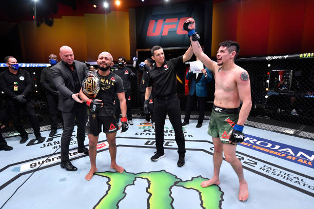 Deiveson Figueiredo of Brazil and Brandon Moreno of Mexico react after their flyweight championship bout was declared a majority draw during the UFC...