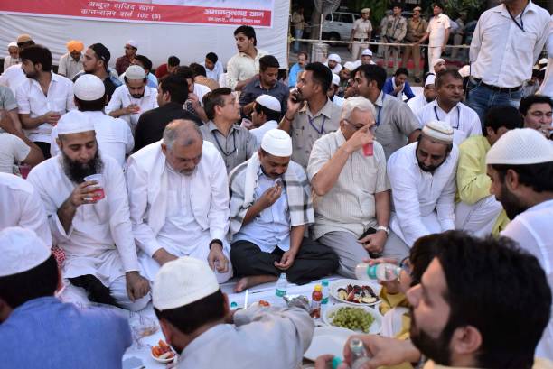 Delhi Chief Minister Arvind Kejriwal along with AAP MLA Amanatullah Khan during an Iftar party at Ansari Auditorium in Jamia Milia University on June...