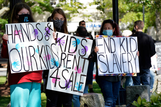 Demonstrators in Keene, New Hampshire, gather at a "Save the Children Rally" to protest child sex trafficking and pedophilia around the world, on...