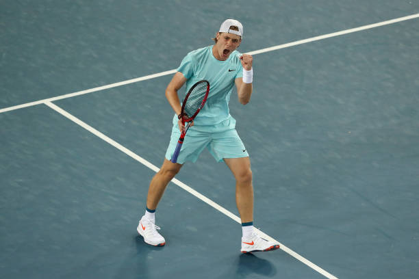 Denis Shapovalov of Canada celebrates winning set point in his Men's Singles first round match against Jannik Sinner of Italy during day one of the...