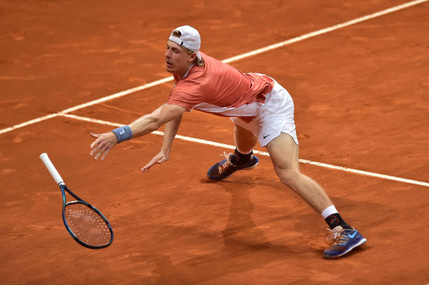 Denis Shapovalov of Canada falls to the floor in their second round match against Andy Murray of Great Britain during day six of Mutua Madrid Open at...