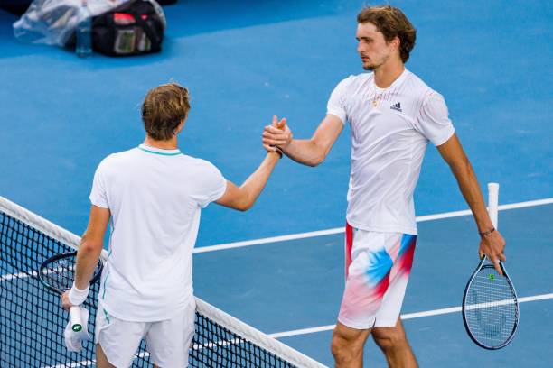 Denis Shapovalov of Canada shakes hands with Alexander Zverev of Germany after winning match point in his fourth round singles match during day seven...