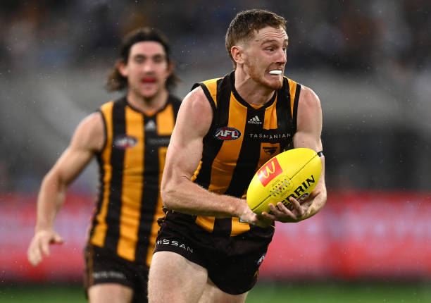 Denver Grainger-Barras of the Hawks handballs during the round five AFL match between the Hawthorn Hawks and the Geelong Cats at Melbourne Cricket...