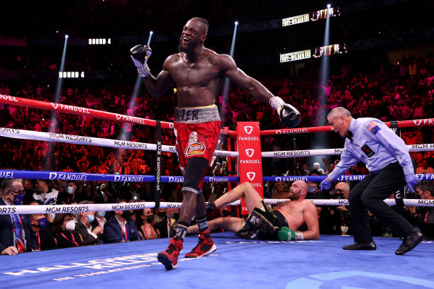 Deontay Wilder reacts after knocking down Tyson Fury in the fourth round during their WBC heavyweight title fight at T-Mobile Arena on October 09,...