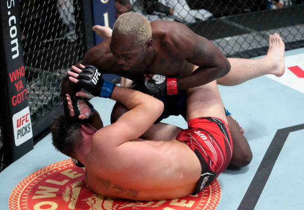 Derek Brunson punches Darren Till of England in their middleweight fight during the UFC Fight Night event at UFC APEX on September 04, 2021 in Las...