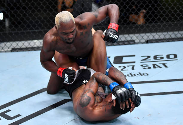 Derek Brunson punches Kevin Holland in their middleweight fight during the UFC Fight Night event at UFC APEX on March 20, 2021 in Las Vegas, Nevada.