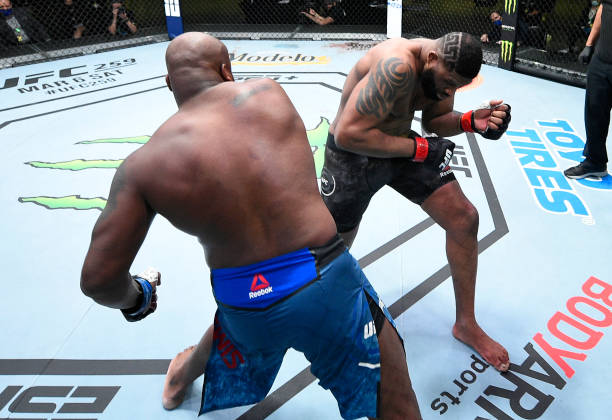 Derrick Lewis punches Curtis Blaydes in a heavyweight bout during the UFC Fight Night event at UFC APEX on February 20, 2021 in Las Vegas, Nevada.