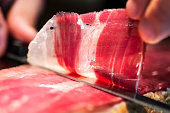 Detail of knife cutting jamon iberico