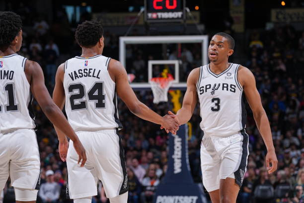 Devin Vassell and Keldon Johnson of the San Antonio Spurs high five during the game against the Denver Nuggets on April 5, 2022 at the Ball Arena in...