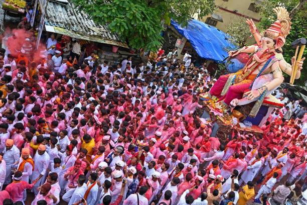 Devotees carry an idol of the elephant-headed Hindu deity Ganesha during an immersion procession to the Arabian sea on the last day of Ganesh...