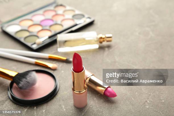 different luxury makeup products grey background