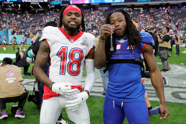 Diontae Johnson of the Pittsburgh Steelers and Alvin Kamara of the New Orleans Saints pose on the field as Kamara gives Johnson a chain before the...