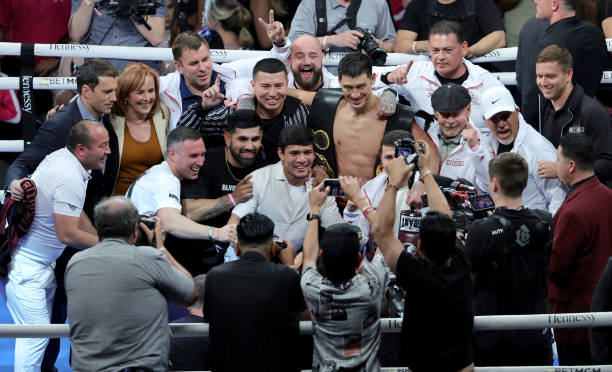 Dmitry Bivol celebrates with his team after his unanimous-decision victory over Canelo Alvarez in their WBA light heavyweight title fight at T-Mobile...