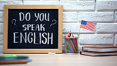 Do you speak English written on board, international flag in box, language