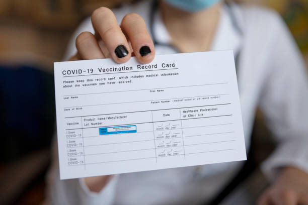 doctor-holding-covid19-vaccination-recor