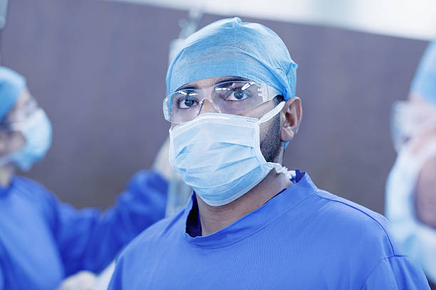 Doctor looking upward to monitor in hospital operating room