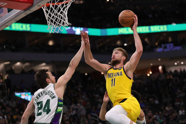 Domantas Sabonis of the Indiana Pacers shoots over Pat Connaughton of the Milwaukee Bucks during the second half of a game at Fiserv Forum on...