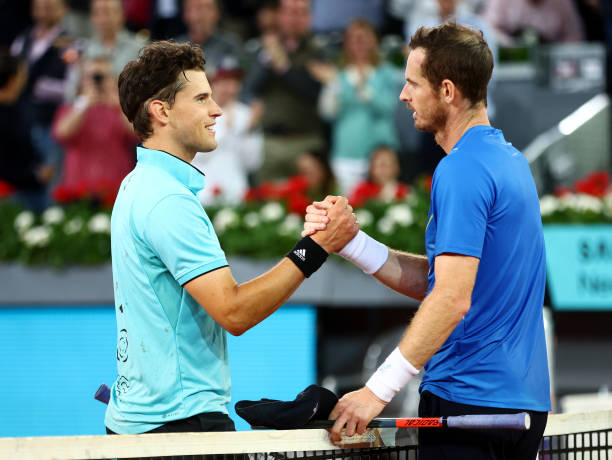 Dominic Thiem of Austria shakes hands with Andy Murray of Great Britain after their First Round match on day five of the Mutua Madrid Open at La Caja...