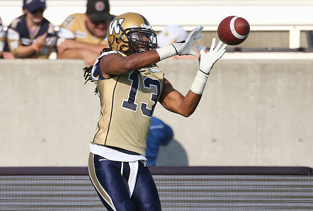 Don Unamba of the Winnipeg Blue Bombers warms up before the start of CFL game action against the Hamilton Tiger-Cats on July 31, 2014 at Ron Joyce...