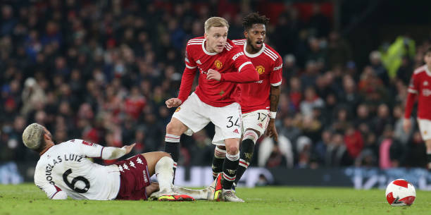 Donny van de Beek of Manchester United in action with Douglas Luiz of Aston Villa during the Emirates FA Cup Third Round match between Manchester...