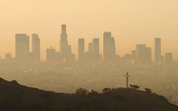 Downtown highrise buildings are shown cloaked in dirty air shortly after sunrise September 11, 2002 in Los Angeles, California. Although air quality...