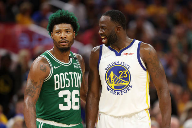 Draymond Green of the Golden State Warriors talks to Marcus Smart of the Boston Celtics during the third quarter in Game Two of the 2022 NBA Finals...