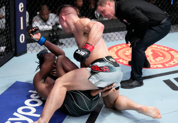 Drew Dober punches Terrance McKinney in their lightweight fight during the UFC Fight Night event at UFC APEX on March 12, 2022 in Las Vegas, Nevada.