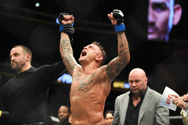 Dustin Poirier celebrates after recieving the title belt from UFC President Dana White during the UFC 236 event at State Farm Arena on April 13, 2019...