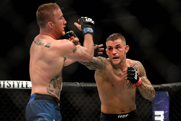 Dustin Poirier punches Justin Gaethje in their lightweight fight during the UFC Fight Night event at Gila River Arena on April 14, 2018 in Glendale,...