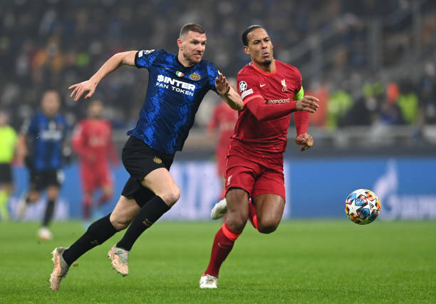 Edin Dzeko of FC Internazionale and Virgil van Dijk of Liverpool battle for possession during the UEFA Champions League Round Of Sixteen Leg One...