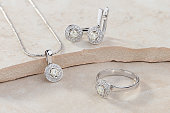 Elegant jewelry set of white gold ring, necklace and earrings with diamonds