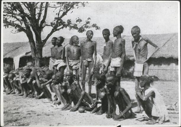 Emaciated people at Jubbulpore during a famine In India, 1897. From 'Black & White'.