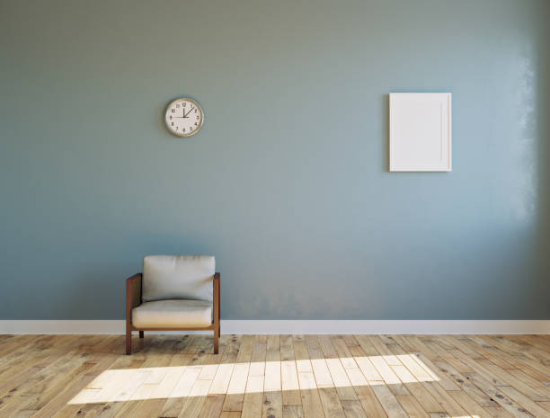 empty sunlit room with armchair and clock on the wall - wallpapers for walls room stock pictures, royalty-free photos & images
