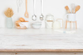 Empty wooden table on blurred kitchen accessories background, copy space
