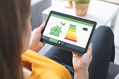 Energy efficiency mobile app on screen, eco house