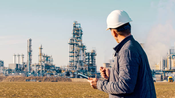 engineer using tablet near oil refinery picture