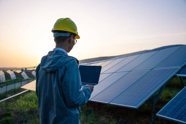 engineer working with a laptop in solar power station picture