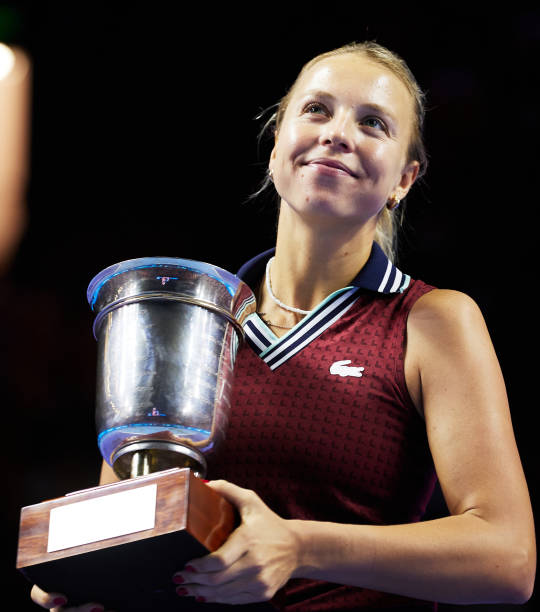 Estonia's Anett Kontaveit celebrates with the trophy after winning the women's singles final match against Russia's Ekaterina Alexandrova during on...