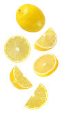falling, hanging, flying whole and half piece of lemon fruits isolated on white background with clipping path