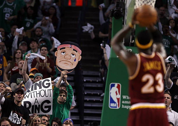 Fans try to distract LeBron James of the Cleveland Cavaliers as he tries to shoot a free throw in the first half against the Boston Celtics during...